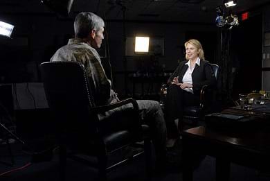 A photograph shows two people talking, face-to-face in a dark TV studio. This was a sit-down interview with Air Force Chief of Staff Gen. Norton Shwartz by Lara Logan for 60 Minutes on April 15, 2009.
