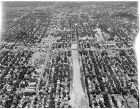 An aerial view of Interstate 35W under construction through neighborhoods in south Minneapolis in the 1960s