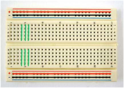 Photo shows a breadboard (circuit board) that has nothing connected to it. Colored lines are drawn over the breadboard to indicate which terminals are connected to each other. 