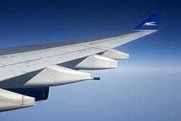 A photograph shows the wing of a jet during flight.