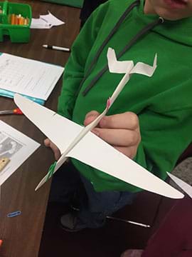 A completed paper glider made by a student.
