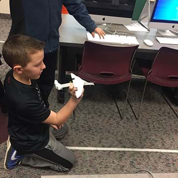 A student testing their airplane. 