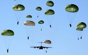 Paratroopers of the U.S. Army's 4th Brigade Combat Team parachute over the Malemute Drop Zone in Alaska.