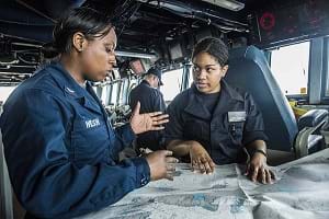 Sailors conduct navigation training aboard the USS Mustin.