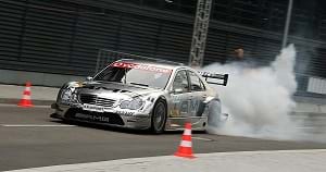 A Mercedes-Benz DTM car driven on a race track.