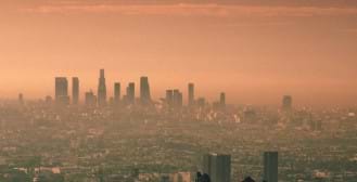 A photograph of a city skyline distorted and discolored due to smog.