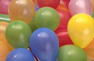 A photograph of a mass of colorful blown-up plastic balloons.
