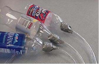 A photograph shows three different test bottle setups with varying diameter tubes.