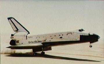 Photo shows an aircraft with side wings and upper rudder rolling on its back wheels with the nose silghtly up.