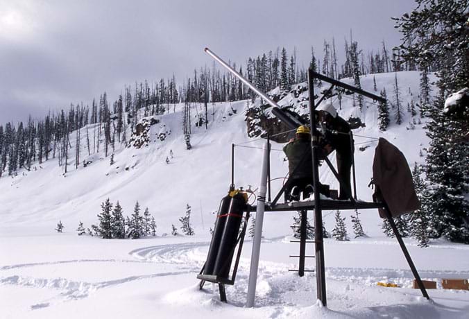 Photo of a snowy mountain scene with a metal contraption in the foreground.
