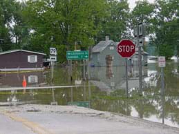 A street intersection is submerged in water.