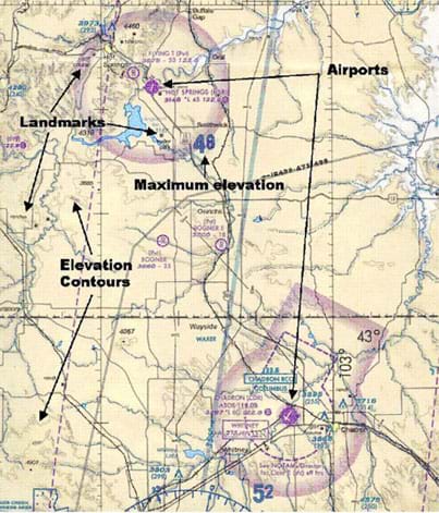 A portion of an aeronautical chart showing land and water areas, marked with elevations, elevation contour lines, airport airspace boundaries, roads and other identified landmarks.