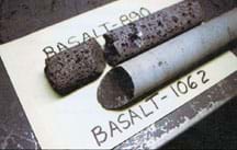 Photo of two rock cylinders of basalt, one porous and the other smooth.