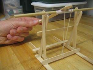 A photograph of a finished catapult constructed by students with tongue depressors and popsicle sticks.
