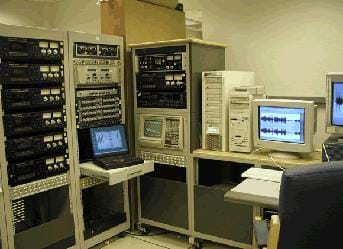 Photo shows a room full of equipment, computers and monitors.