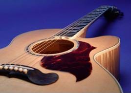 Photograph of a six-stringed wooden guitar.