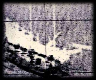 Grainy image shows the shape of a sunken ship.