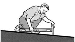 A black and white graphic of a man measuring slope using a 24-inch level and tape measure.