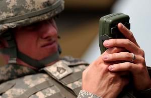 A staff sergeant in the army using a GPS receiver.