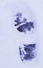 Photo shows a person's boot print in snow.