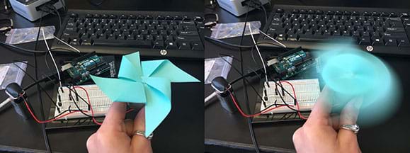 Two photographs show the same scene. In the background, a desktop setup of a spinning motor circuit on a wired breadboard connected to Arduino. In the foreground: A hand holds a small motor with a four-blade, pinwheel-shaped fan made of angle-folded blue paper sticky notes attached to it. On the left, the motor is off so you can clearly see the pinwheel fan. On the right, the motor is on and the fan is a blur (spinning).