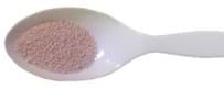 A photograph of a plastic spoon with yeast in the spoon.