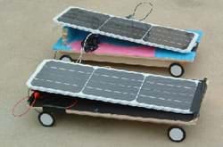 Two solar cars look like four-wheeled skateboards with angled solar panels on top. Built by middle school students from Rogers Herr Middle School in Durham, NC, while participating in the Duke University Techtronics Program.