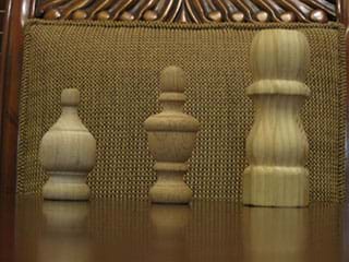 A photograph shows three wooden finials of varying sizes; they look somewhat like chess pieces. A finial is a distinctive ornament at the apex of a roof, pinnacle, canopy or similar structure in a building or object (such as a lamp).