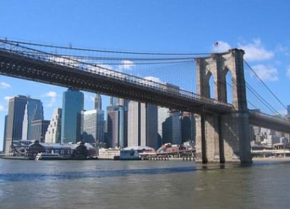 Photograph of the Brooklyn Bridge with the skyscrapers of Manhattan in the background.