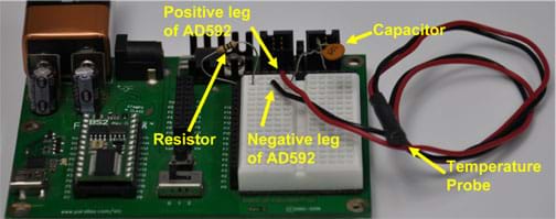 Photo shows a circuit board with attachments labeled: resistor, positive leg of AD592, negative leg of AD592, capacitor and temperature probe.
