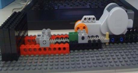 A photograph shows LEGO plastic parts, a compressor and motor.