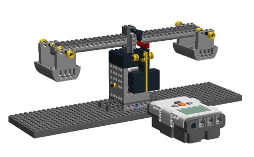 The image shows the final construction of LEGO balance scale created with a computer graphics program. The overall design is a two-sided balance, with a LEGO brick in front.