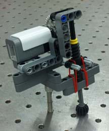 Photo shows a pressure sensor comprised of a rotation sensor, rubber bands, and other LEGO pieces. 