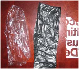 A photograph shows three rectangles of different types of plastic materials suitable for this activity. Left to right: a lightweight clear plastic (from a dry cleaning bag); a dark-colored slightly heavier plastic (from a trash bag); and a thicker plastic with writing printed on it (from a department store bag).