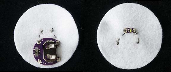 A photograph shows the back and front of a three-inch round white felt circle after a battery holder and an LED board are sewed down on opposite sides using conductive thread. 