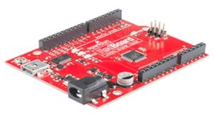 A photograph shows a circuit board with its base board a bright red color.