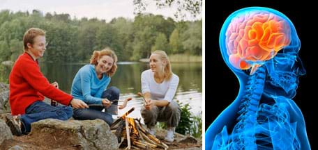 Photo shows three teens using sticks to roast hot dogs over the flames of a campfire by a lake. A blue x-ray-like image shows the shoulders, spinal cord and brain in a skull.