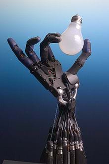 An image shows a dexterous robot hand and wrist, which appears to be delicately screwing in a light bulb.