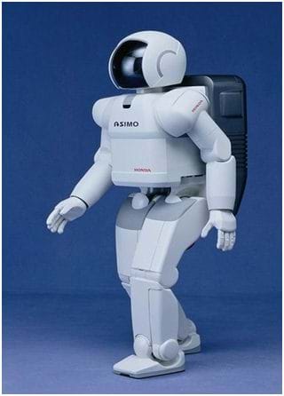 Photo shows a bi-pedal robot that looks like a man in a white spacesuit and helmet.