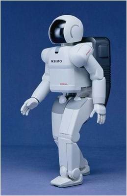 A photo of a bi-pedal robot that looks like a man in a white space suit and helmet.
