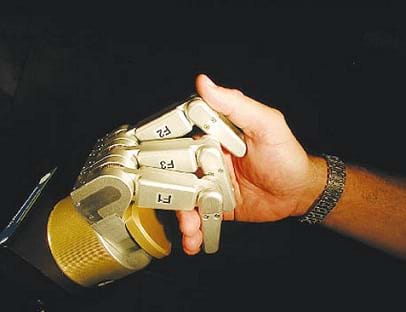 A photograph shows a handshake between a human hand and a robot hand.