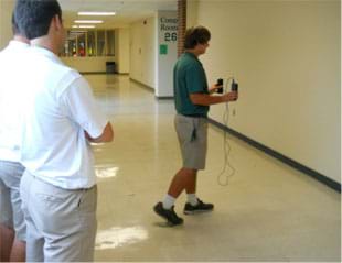 A photograph shows a student in a school hallway using an accelerometer to collect data on his gait.