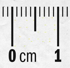 An up-close image of ruler markings of 0 cm and 1 cm, with small lines indicating each tenth of a centimeter. Barely noticeable yellow dots are scattered between 0 cm and 1cm.