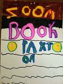 A photograph shows a hand-drawn book cover with the title, “Zoom Book by Paxton.”