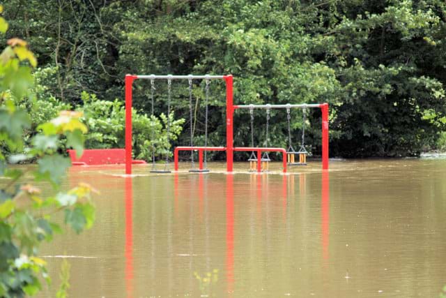 An image of a children’s playground set under several feet of water. 
