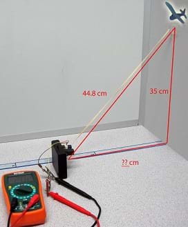 Photo shows a multimeter, airplane cutout, and Sharp GP2Y0A02YK0F sensor aimed at a wall. While the distance to the wall is unknown, the vertical distance along the wall to a clipart airplane is shown as 35 cm and the diagonal (slant range) distance from the clipart airplane to the sensor is shown as 44.8 cm.