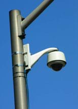 Photo shows a security camera on a street corner, another security system design.
