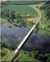 Aerial photo shows a highway bridge across a river.