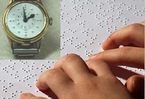 A photograph shows a child's hands resting on a braille tablet. A watch is superimposed on top of the tablet.