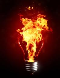 Photo shows flames pouring from a screw-in light bulb.